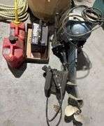 Evanrude Super Fastwin boat motor, battery, and gas cans