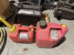 Evanrude Super Fastwin boat motor, battery, and gas cans
