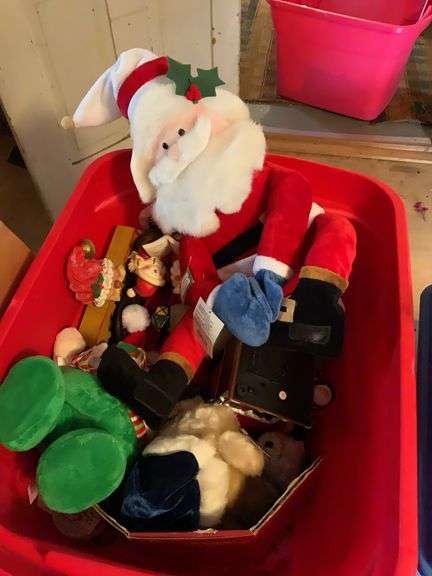 Tote filled with Santa Clauss, singing, dancing, and also Santa figurines