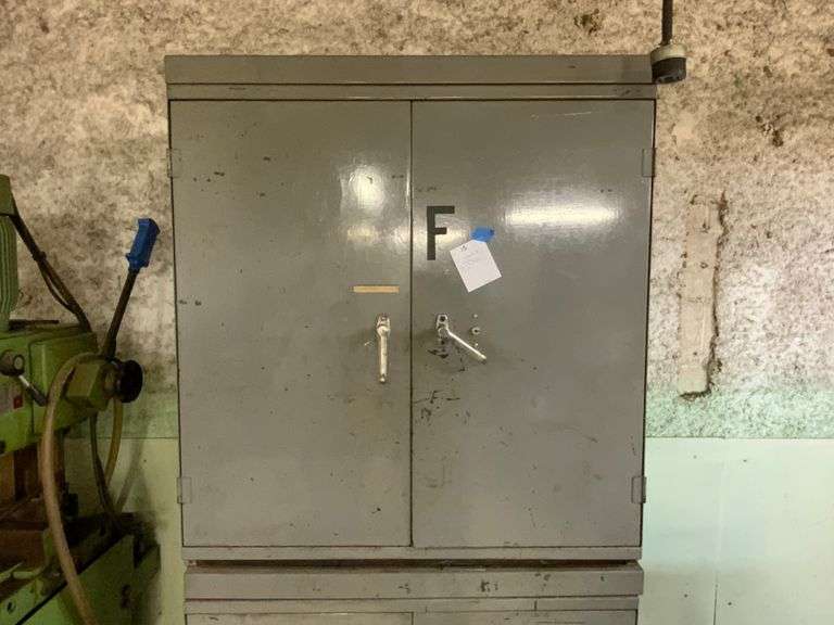 "F" metal cabinet and contents.