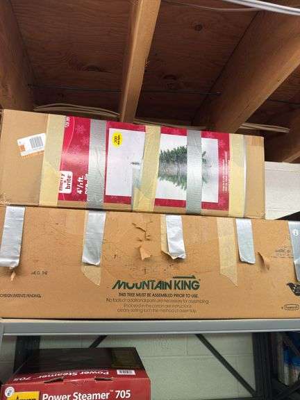 Two Christmas trees in boxes, one is 4 1/2 feet tall