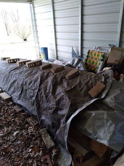 Contents of carport includes aluminum extension ladder, some furniture, vintage lawn decor, water bottle, doors. Take what you want leave the rest