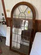 Family room: vintage parlor mirror with some spray paint, Leaded glass cabinet door, marble table top.