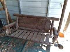 Rustic log bench swing in carport