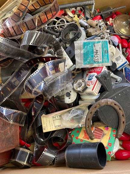 Large lot of very miscellaneous items. Keys. Accessories. Belt buckles. Film roll. Wallet. Decor. Vintage Christmas lights. Dice and much much more.