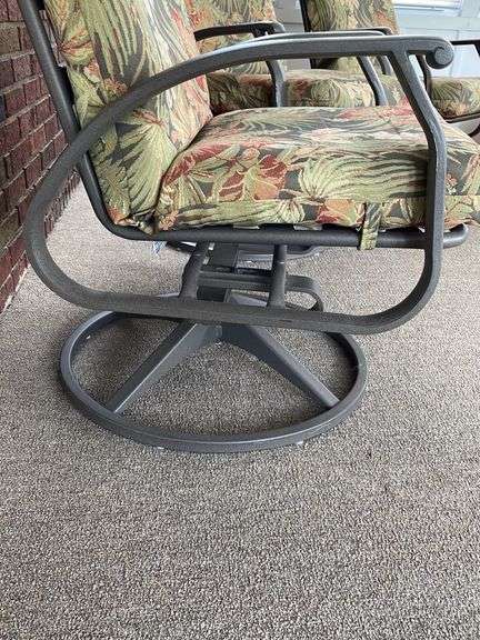 Three outdoor swivel rocking chairs. With clean floral cushions. In good shape.