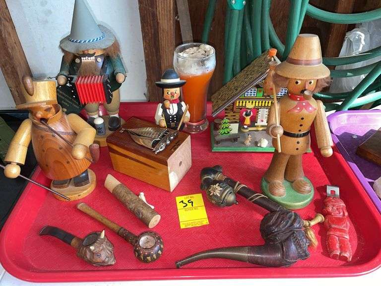 Garage. Lot features. Volkskunst nutcracker/figurines. Unique carved smoking pipes. Bavarian style thermometer with carvings. Native American bottle opener vintage by Iroquois.