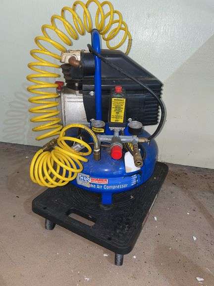 Garage. HDC pancake compressor mounted on small movers dolly