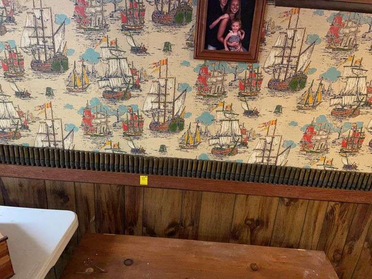 Basement. Spent 50 caliber rounds decor. Screwed into wall please bring tools to remove this. This is one piece. Approximately 6 feet long. Unique.