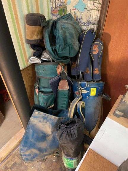 Basement. Two bags of golf clubs. And small camping fold up table.