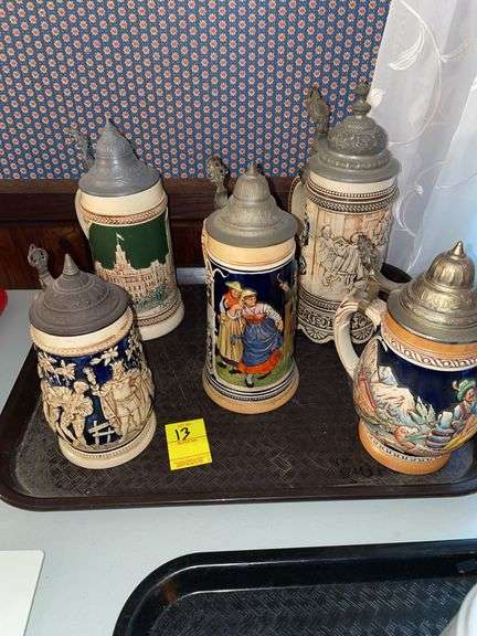 Den. Five German Steins all with lid covers.