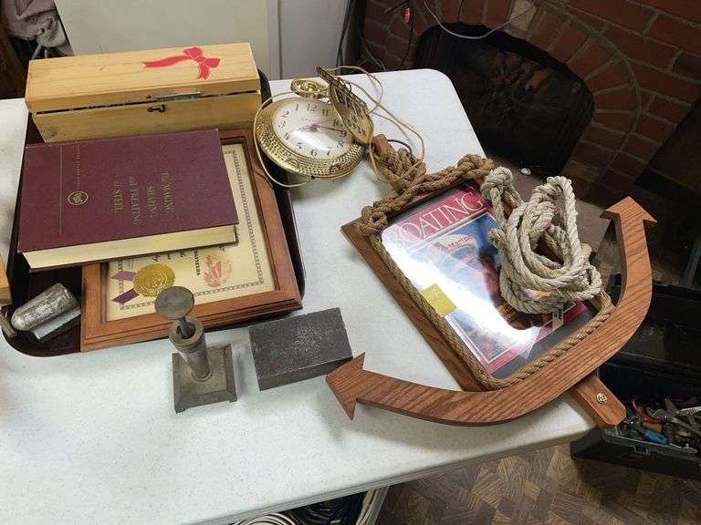 Basement. Large lot of decor featuring unique wall clock. Block of steel. Another miscellaneous items.