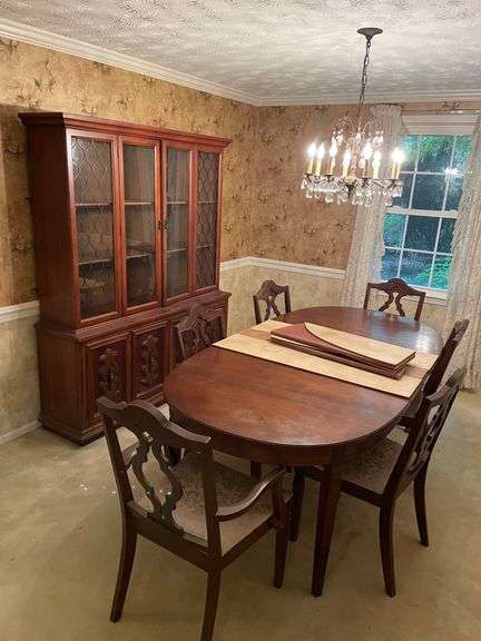 Dark wood dining room table with matching China cabinet. Six matching chairs included.