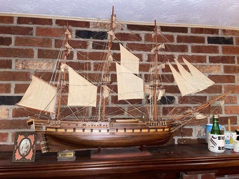 Dan. USS Constitution ship model approximately 43 inches long 30 inches tall with small placard and vintage framed photograph of sailor