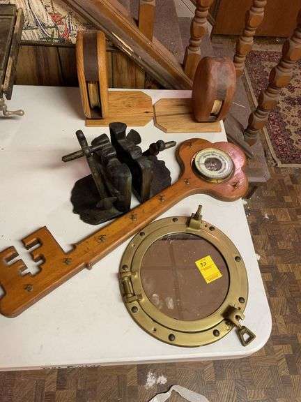 Basement. Lot of unique decor. Featuring portal mirror, heavy cast anchor book ends.