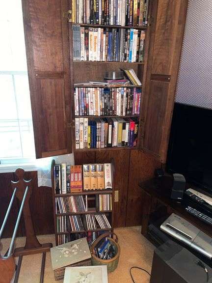 Den. Large collection of DVDs. Some Blu-ray. And a few VHS. And CDs. Small CD stand on floor is include included.