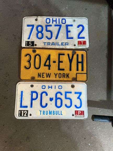 Garage. Three vintage license plate plates.