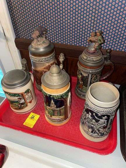 Den. Five unique Steins, some with German writing. And unique finial covers.