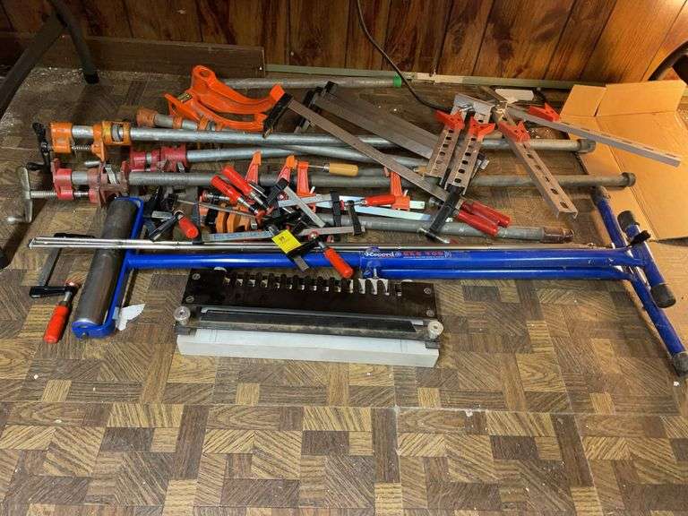 Basement. Enormous lot of Carpenter clamps. Material feeder and other miscellaneous clamps and tool items.