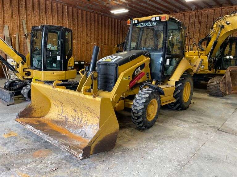 CAT 420E wheeled backhoe/loader. Included air hammer and extra bucket. Full cab. Diesel engine. 93 gross HP. 18 foot dig depth. 8 foot bucket. 1124 hours on meter. Product ID number CT0420EJDJL03017. Serial number C4E21563F1J07325. Garage kept. See photos for video of vehicle running-$1,000 Credit Card Deposit. Balance by Cash, Certified Check or ACH within 48 hours after sale.