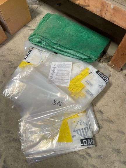 Five each hazmat glove bags, new. Also includes tarp by the piece.