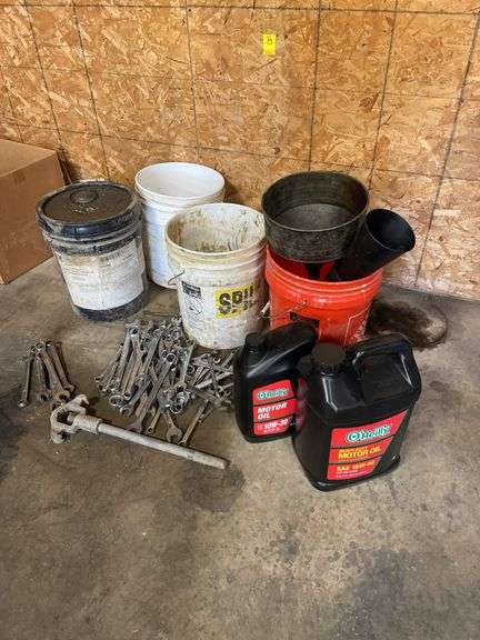 Lot of motor oil. Wrenches, sockets buckets, miscellaneous ratchets.