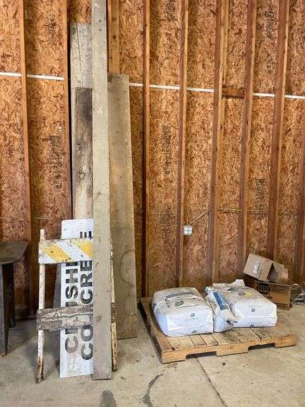 Lot of lumber, signage, and wood pallet.