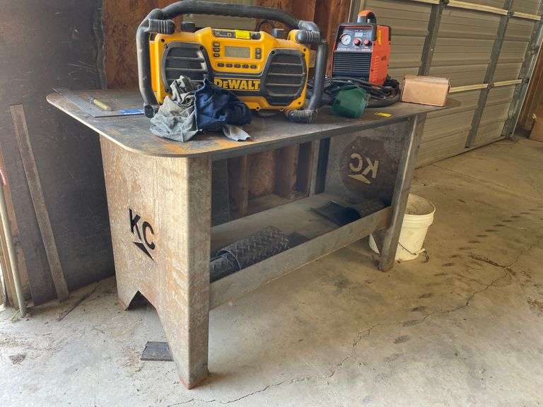 Heavy duty, KC plate metal table very sturdy measures 58 wide by 29 deep with lower shelf.  Bench height.