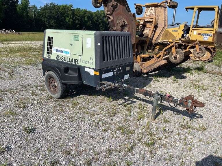 SullAir model 185 portable diesel construction site air compressor. Single axle pool type. Running at setup, started immediately