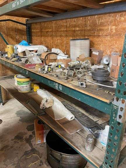 Contents of four post shelving includes oil, change, accessories, and filters for big machinery, miscellaneous hardware, fittings, scrap metal. Take what you want and leave the rest.