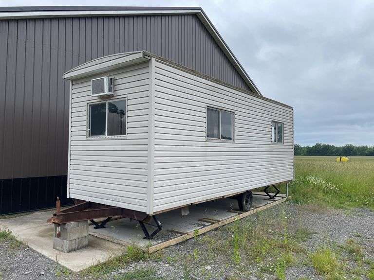Single axle construction trailer. Approximately 8‘ x 24‘. Wired for electric and AC. Interior needs work/finished. Shell only. Vinyl sided. With steps. not sure of ball size