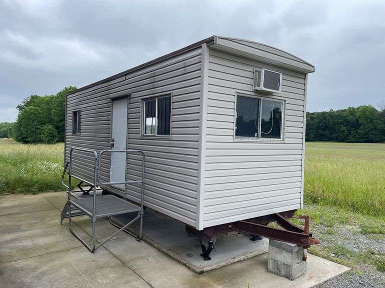 Single axle construction trailer. Approximately 8‘ x 24‘. Wired for electric and AC. Interior needs work/finished. Shell only. Vinyl sided. With steps. not sure of ball size