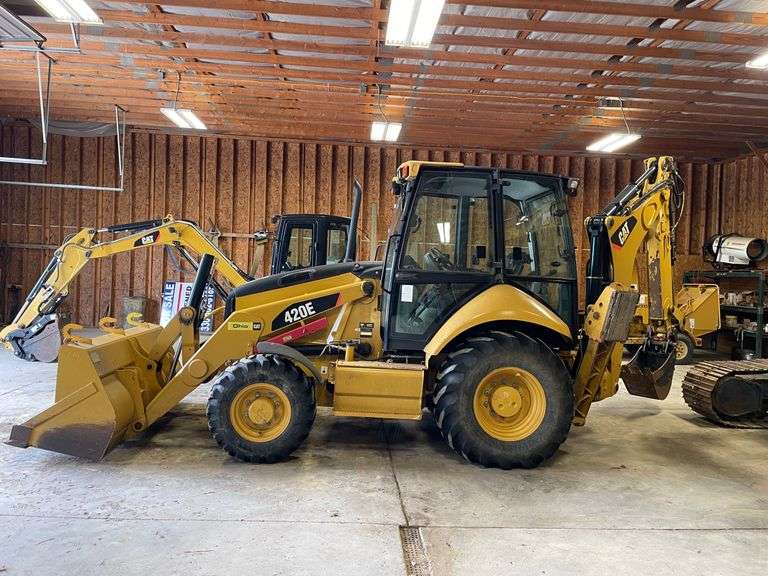 CAT 420E wheeled backhoe/loader. Included air hammer and extra bucket. Full cab. Diesel engine. 93 gross HP. 18 foot dig depth. 8 foot bucket. 1124 hours on meter. Product ID number CT0420EJDJL03017. Serial number C4E21563F1J07325. Garage kept. See photos for video of vehicle running-$1,000 Credit Card Deposit. Balance by Cash, Certified Check or ACH within 48 hours after sale.