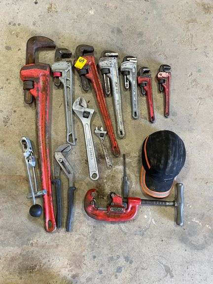 Lot of pipe wrenches, and pipe cutter, mainly rigid with some miscellaneous tools