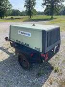 SullAir model 185 portable diesel construction site air compressor. Single axle pool type. Running at setup, started immediately
