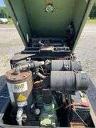 SullAir model 185 portable diesel construction site air compressor. Single axle pool type. Running at setup, started immediately
