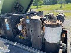 SullAir model 185 portable diesel construction site air compressor. Single axle pool type. Running at setup, started immediately