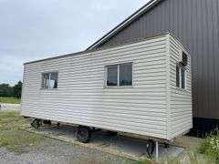 Single axle construction trailer. Approximately 8‘ x 24‘. Wired for electric and AC. Interior needs work/finished. Shell only. Vinyl sided. With steps. not sure of ball size