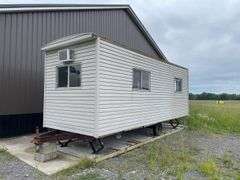 Single axle construction trailer. Approximately 8‘ x 24‘. Wired for electric and AC. Interior needs work/finished. Shell only. Vinyl sided. With steps. not sure of ball size