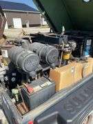 SullAir model 185 portable diesel construction site air compressor. Single axle pool type. Running at setup, started immediately