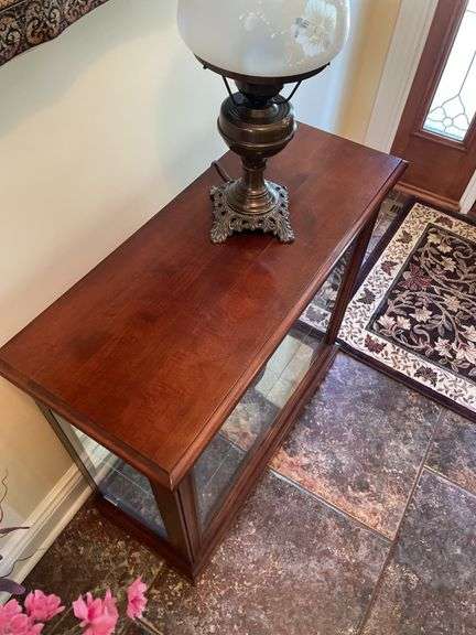 Entryway. Glass front curio. 30 x 28” with oil style electric lamp.