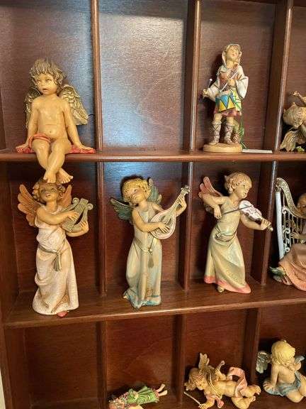 Den. Hanging curio shelf with collection of Daniella Angels.