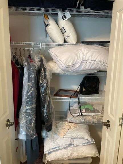 Contents of closet in children’s bedroom. Includes framed prints. Pillows. Some clothing. Fans, craft items, Miscellaneous.