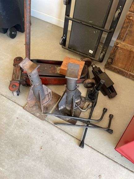 Automotive lot includes floor jacks, creepers, tire irons.