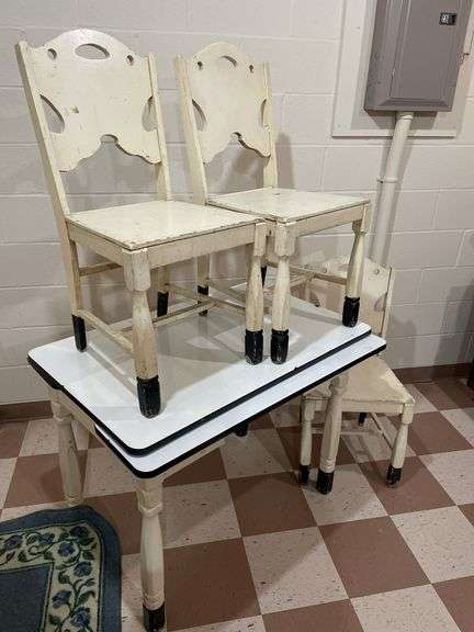 Basement. Enamel top vintage table with three matching wooden chairs. Table is 40 inches wide.