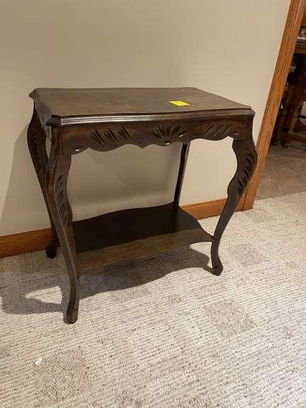 Basement. Small side table with unique carved  design. Approximately 24 inches tall.