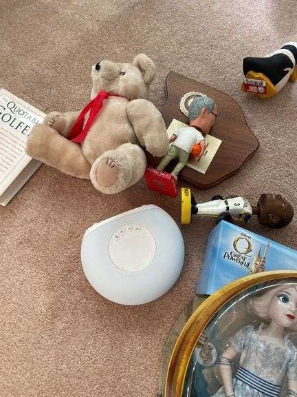 Living room. Lot of dolls and miscellaneous collectibles under table.