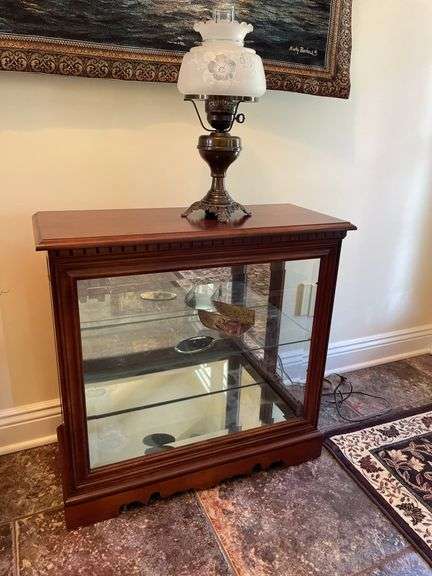 Entryway. Glass front curio. 30 x 28” with oil style electric lamp.
