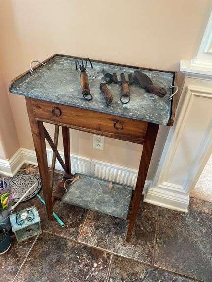 Sunroom. Gardener side table with galvanized top,  with decor tools. Approximately 3 feet tall.