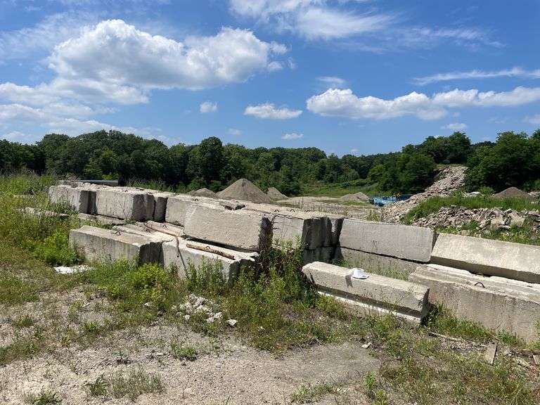 Approximately 84 stackable concrete Bin Blocks. Approximately 6’x2’x2’